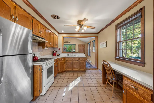 a kitchen with stainless steel appliances granite countertop a stove and a refrigerator