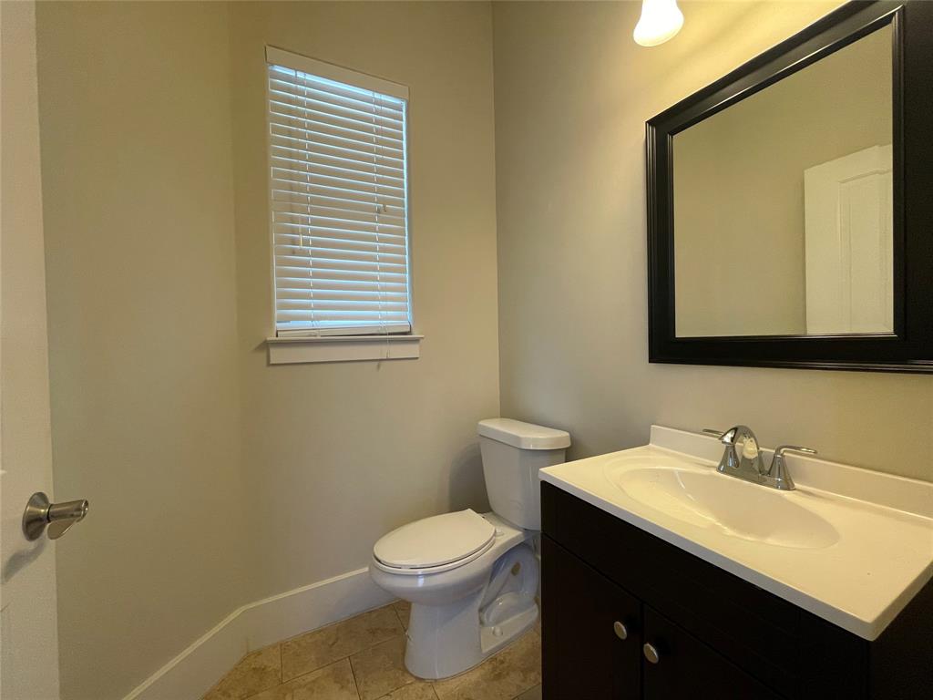 1007 Taulbee Lane, Unit B Austin, TX 78757 - Photo 12 of 36 Half bathroom featuring vanity and light tile patterned flooring