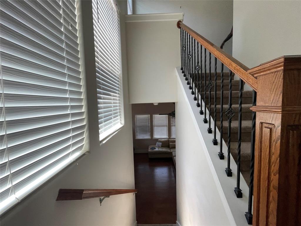 1007 Taulbee Lane, Unit B Austin, TX 78757 - Photo 13 of 36 Staircase featuring a high ceiling and wood finished floors