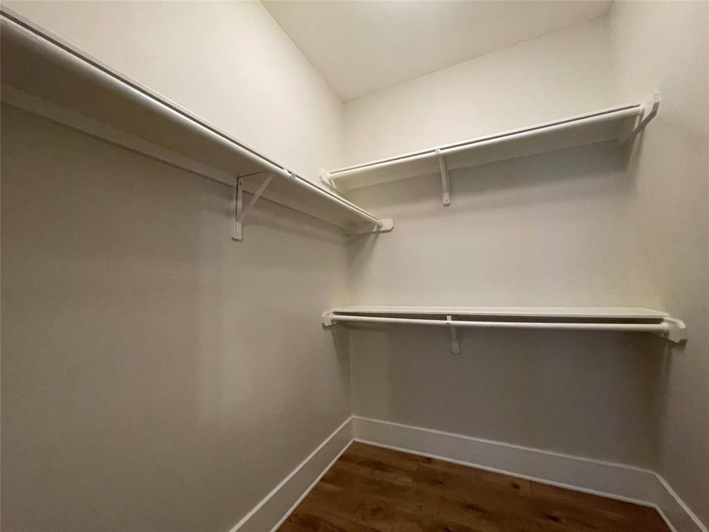 1007 Taulbee Lane, Unit B Austin, TX 78757 - Photo 20 of 36 Walk in closet with dark wood-style floors