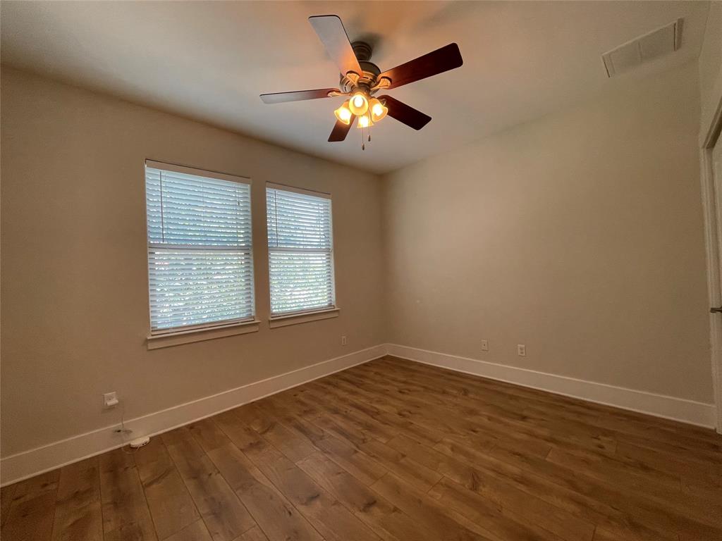 1007 Taulbee Lane, Unit B Austin, TX 78757 - Photo 24 of 36 Empty room featuring dark wood finished floors and a ceiling fan