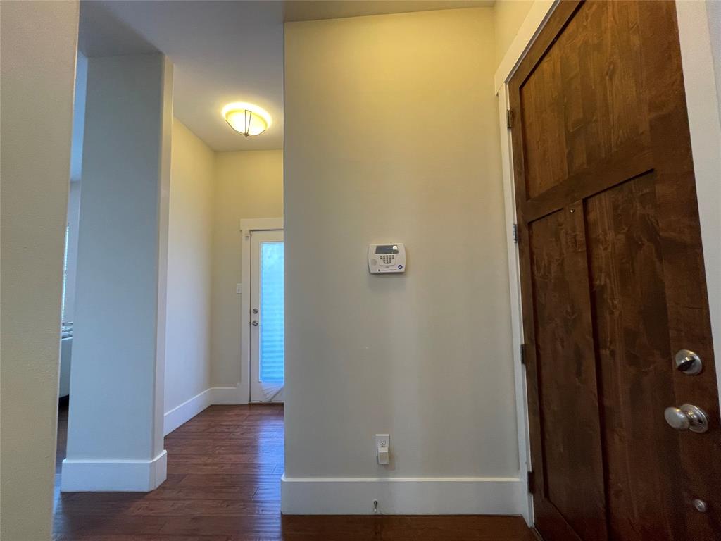 1007 Taulbee Lane, Unit B Austin, TX 78757 - Photo 4 of 36 Corridor featuring dark wood finished floors and baseboards