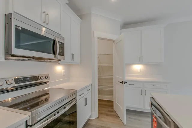 a kitchen with a stove microwave and sink