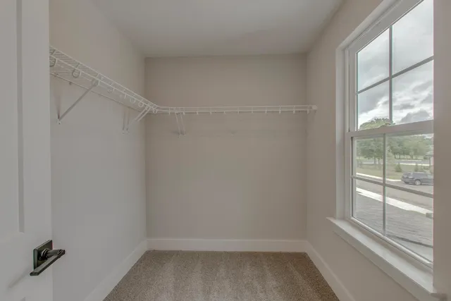 a view of a room with a window and a ceiling fan