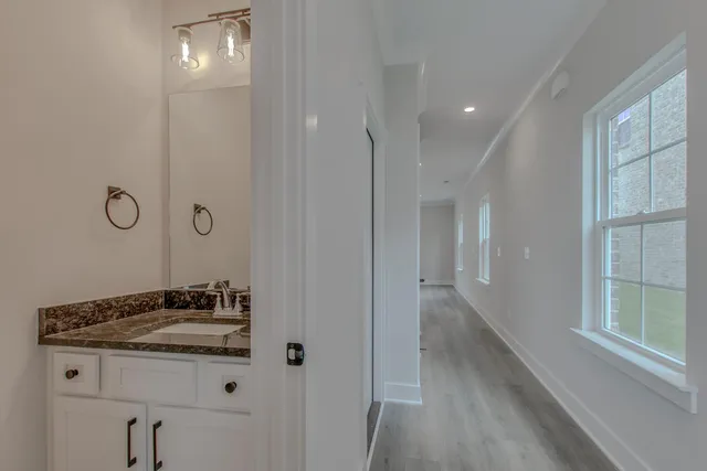 a bathroom with a sink a mirror and a shower