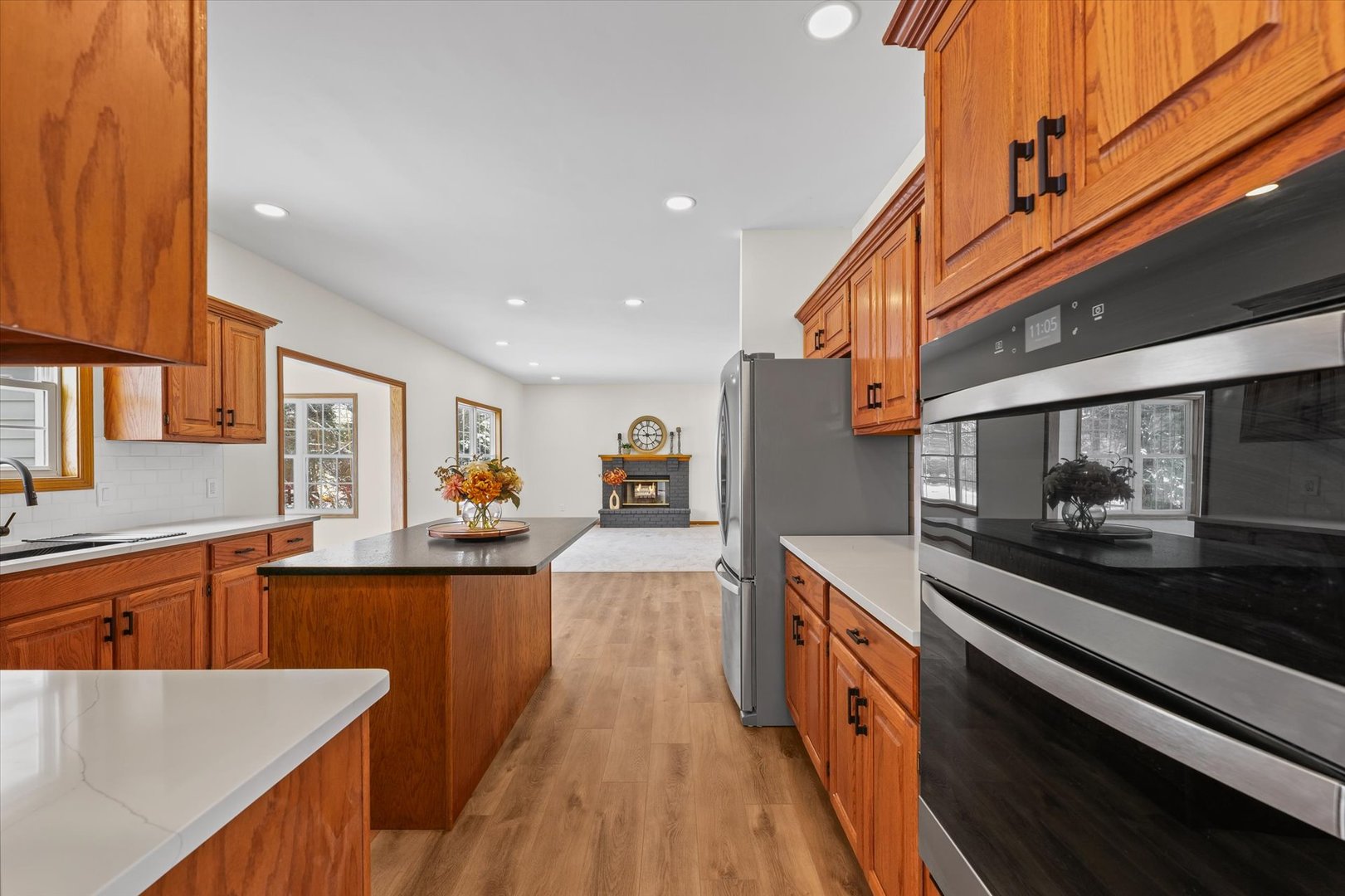 3308 Pebblecreek Place Champaign, IL 61822 - Photo 13 of 57 a large kitchen with stainless steel appliances granite countertop a lot of counter space and wooden floor