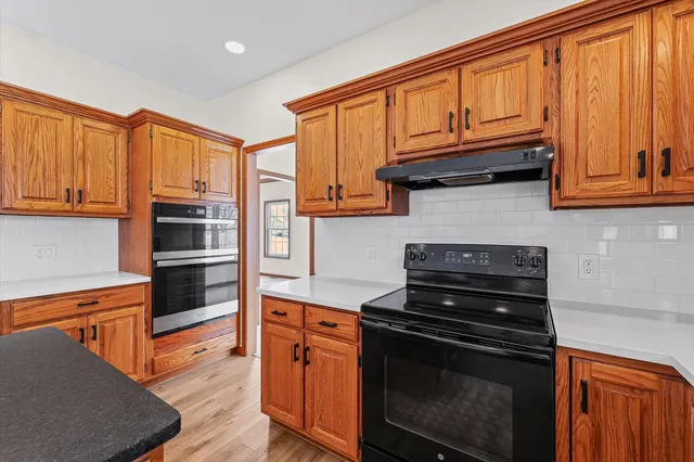 a kitchen with stainless steel appliances a refrigerator and a stove top oven