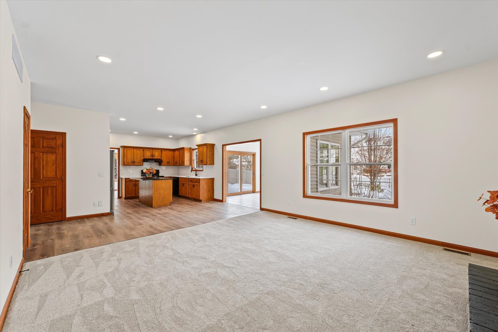 3308 Pebblecreek Place Champaign, IL 61822 - Photo 26 of 57 a view of an empty room with a window and a kitchen