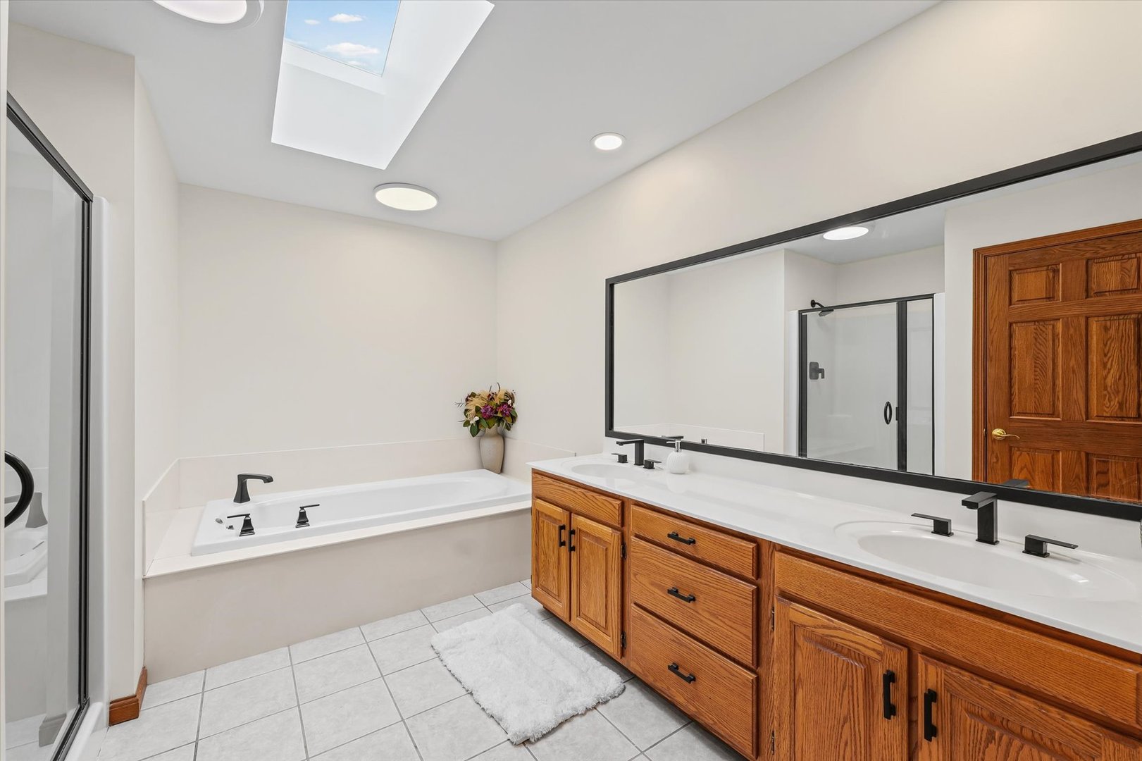 3308 Pebblecreek Place Champaign, IL 61822 - Photo 33 of 57 a bathroom with a tub sink and mirror