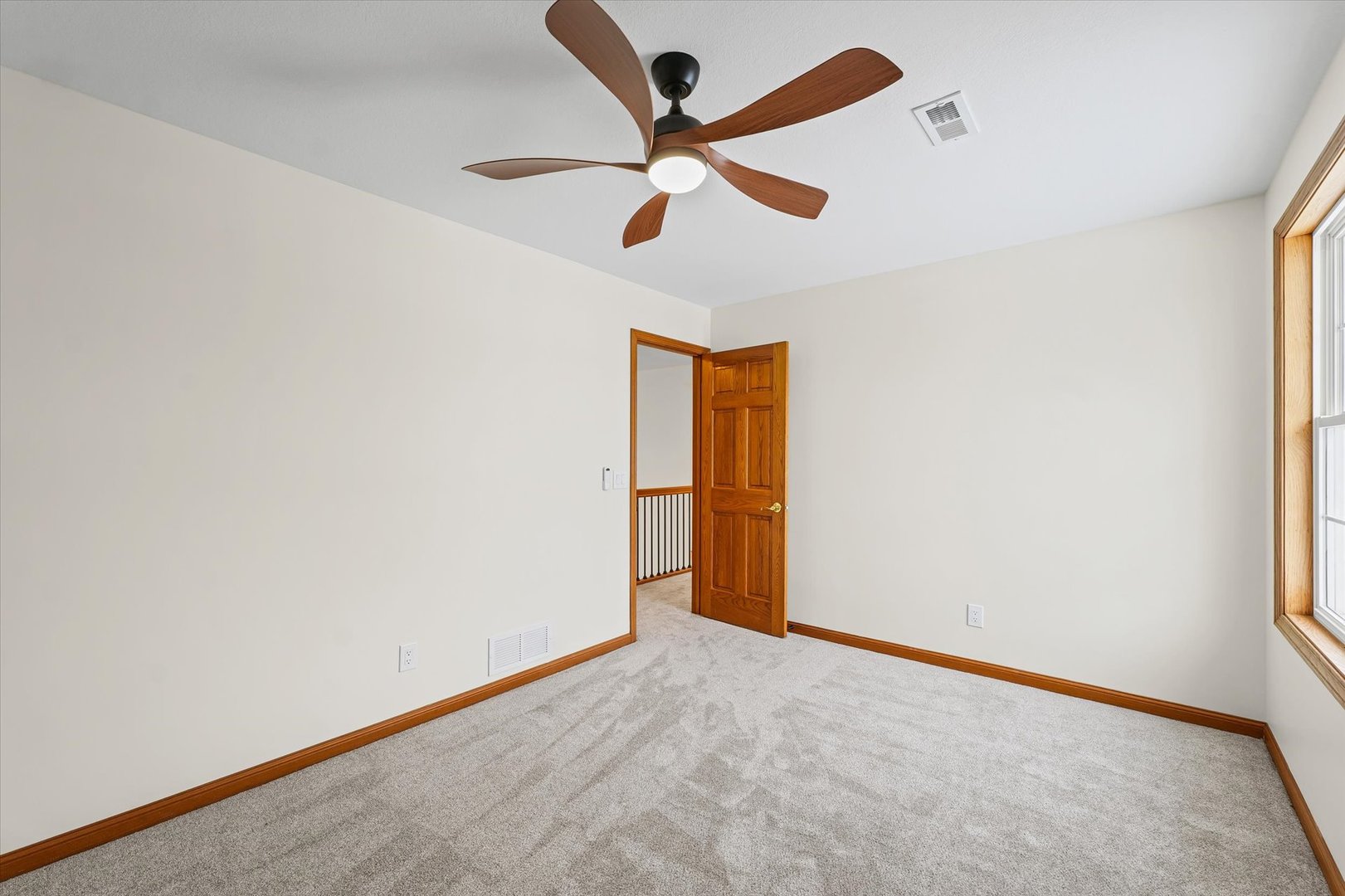 3308 Pebblecreek Place Champaign, IL 61822 - Photo 38 of 57 an empty room with ceiling fan and window