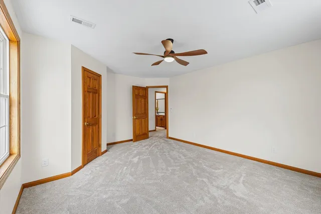 a room with wooden floor and pool table