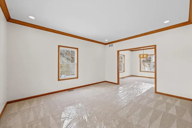 a view of an empty room with a window and closet