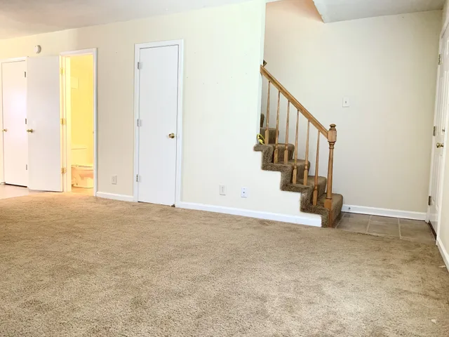 a view of an empty room with stairs
