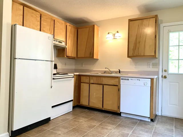 a kitchen with stainless steel appliances a refrigerator sink and cabinets