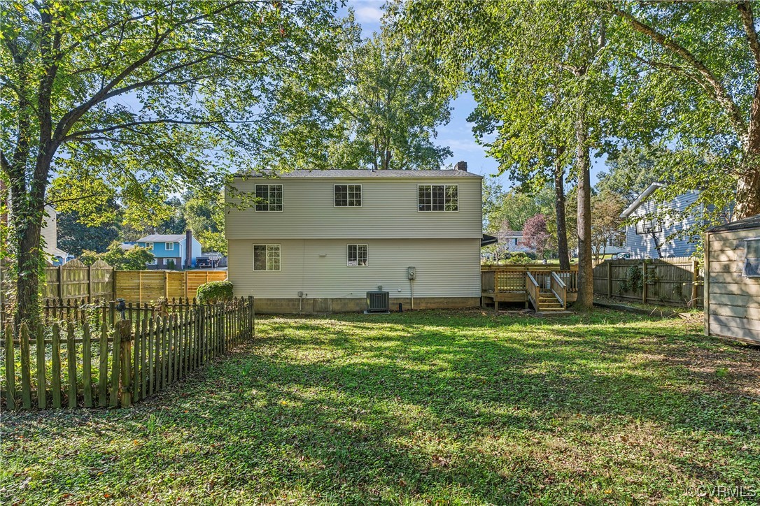 9036 Resaca Road Chesterfield, VA 23236 - Photo 33 of 39 Back of house featuring a deck, a lawn, a fenced b