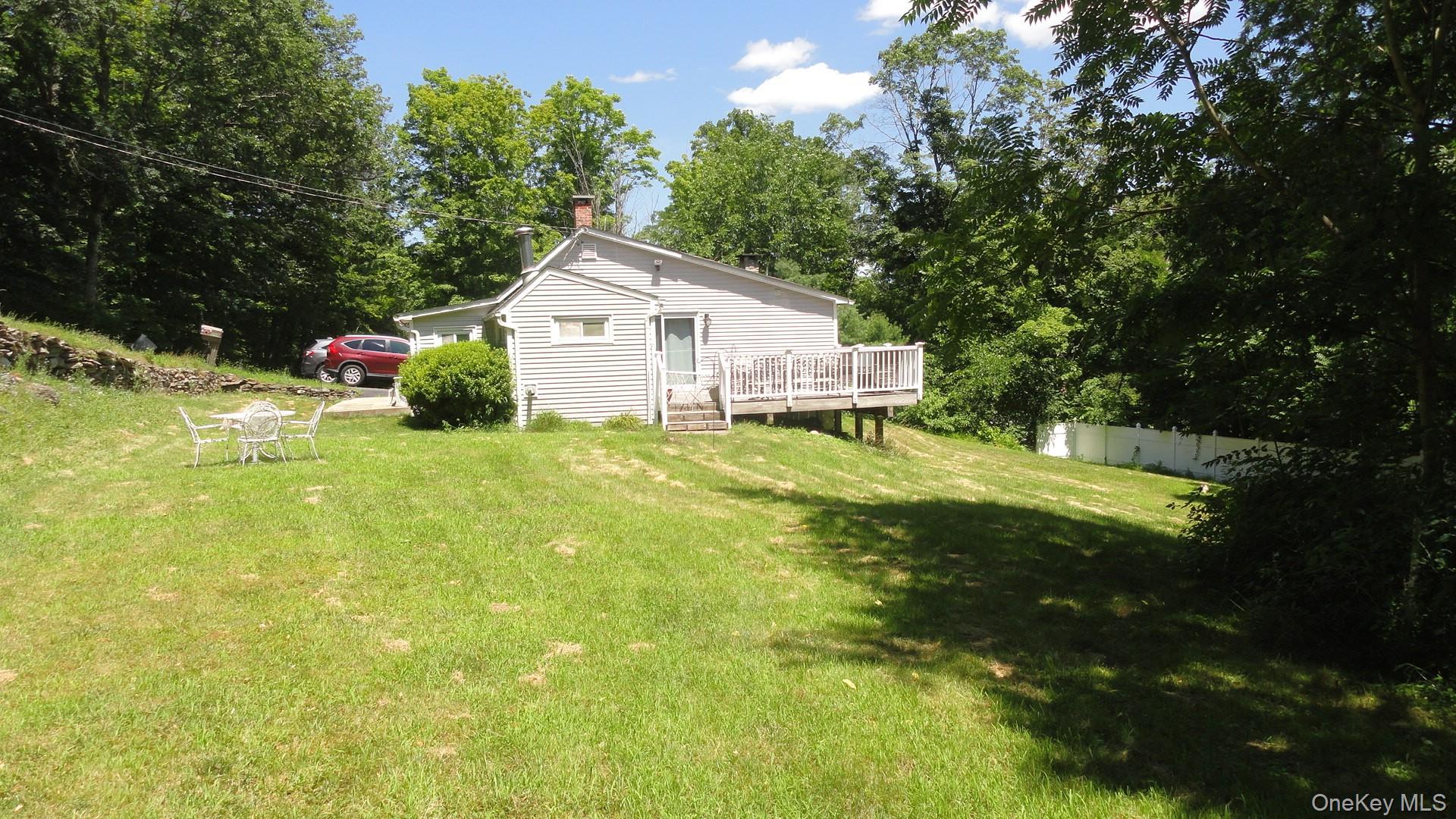 198 Tinkertown Road Salt Point, NY 12578 - Photo 22 of 25 View of side yard featuring a deck and view of wooded area