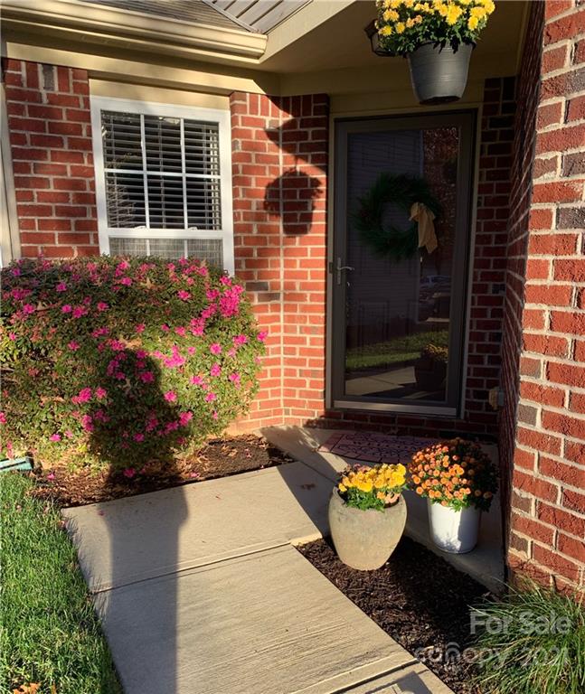 2464 Spring Breeze Way Monroe, NC 28110 - Photo 3 of 5 a front view of a house with a potted plant
