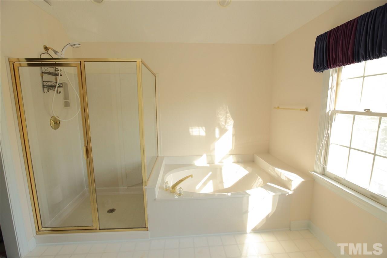5304 Calverton Drive Raleigh, NC 27613 - Photo 14 of 22 a view of a bathroom with a shower