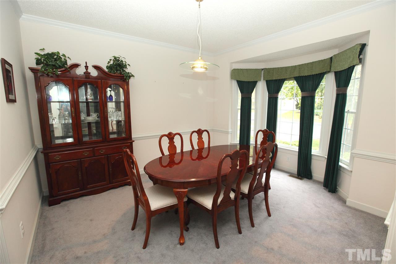 5304 Calverton Drive Raleigh, NC 27613 - Photo 8 of 22 a view of a dining room with furniture window and outside view