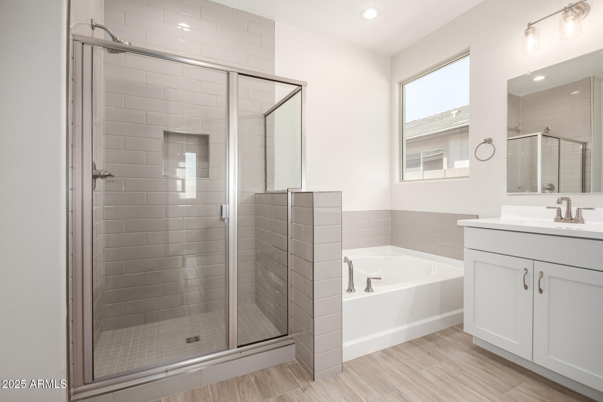 5008 West Roundhouse Road Laveen, AZ 85339 - Photo 14 of 36 a bathroom with a tub shower sink and mirror