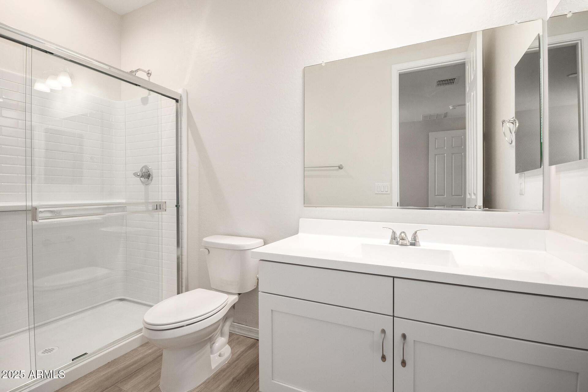 5008 West Roundhouse Road Laveen, AZ 85339 - Photo 19 of 36 a bathroom with a sink a toilet and shower