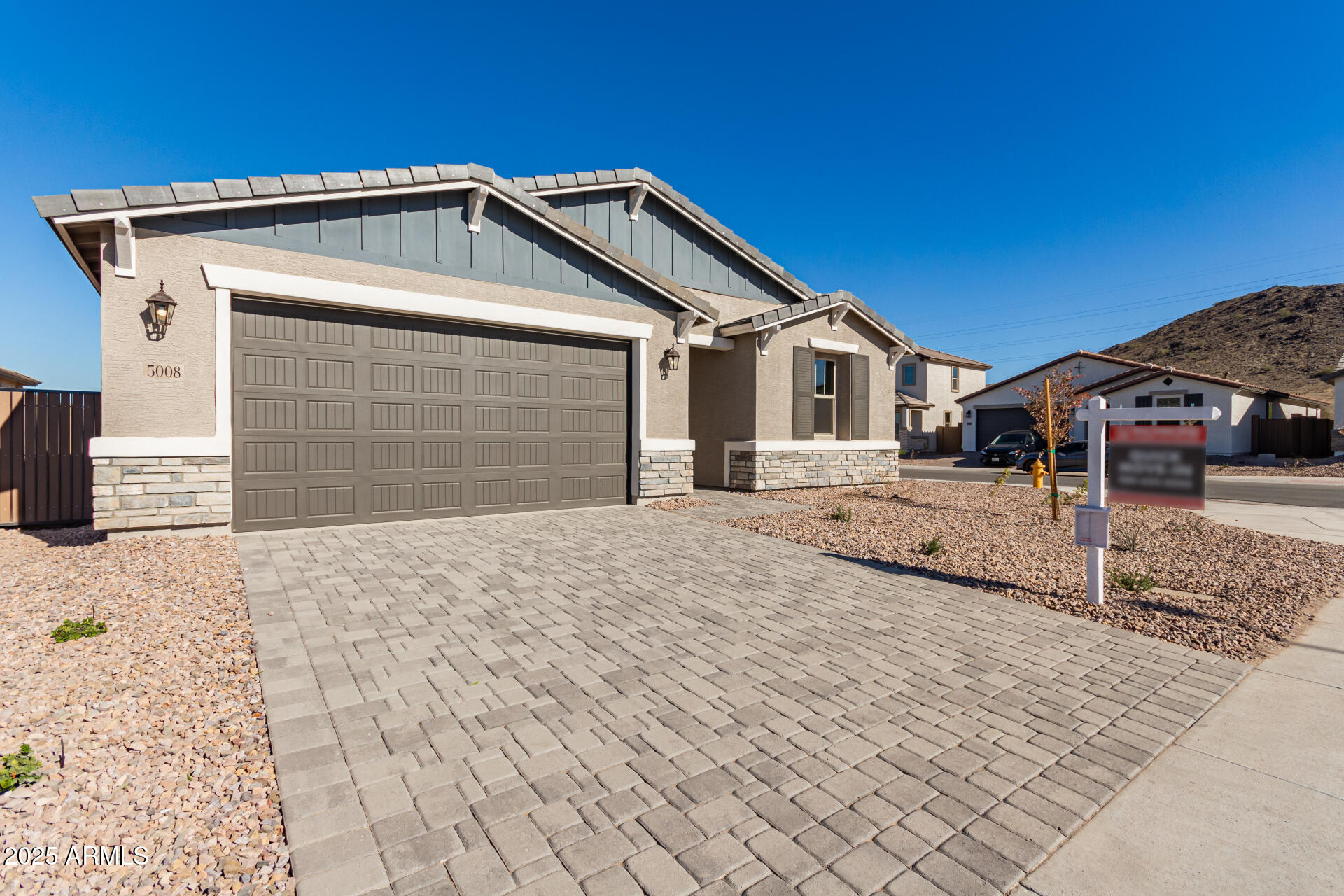 5008 West Roundhouse Road Laveen, AZ 85339 - Photo 34 of 36 a front view of a house with a yard and garage