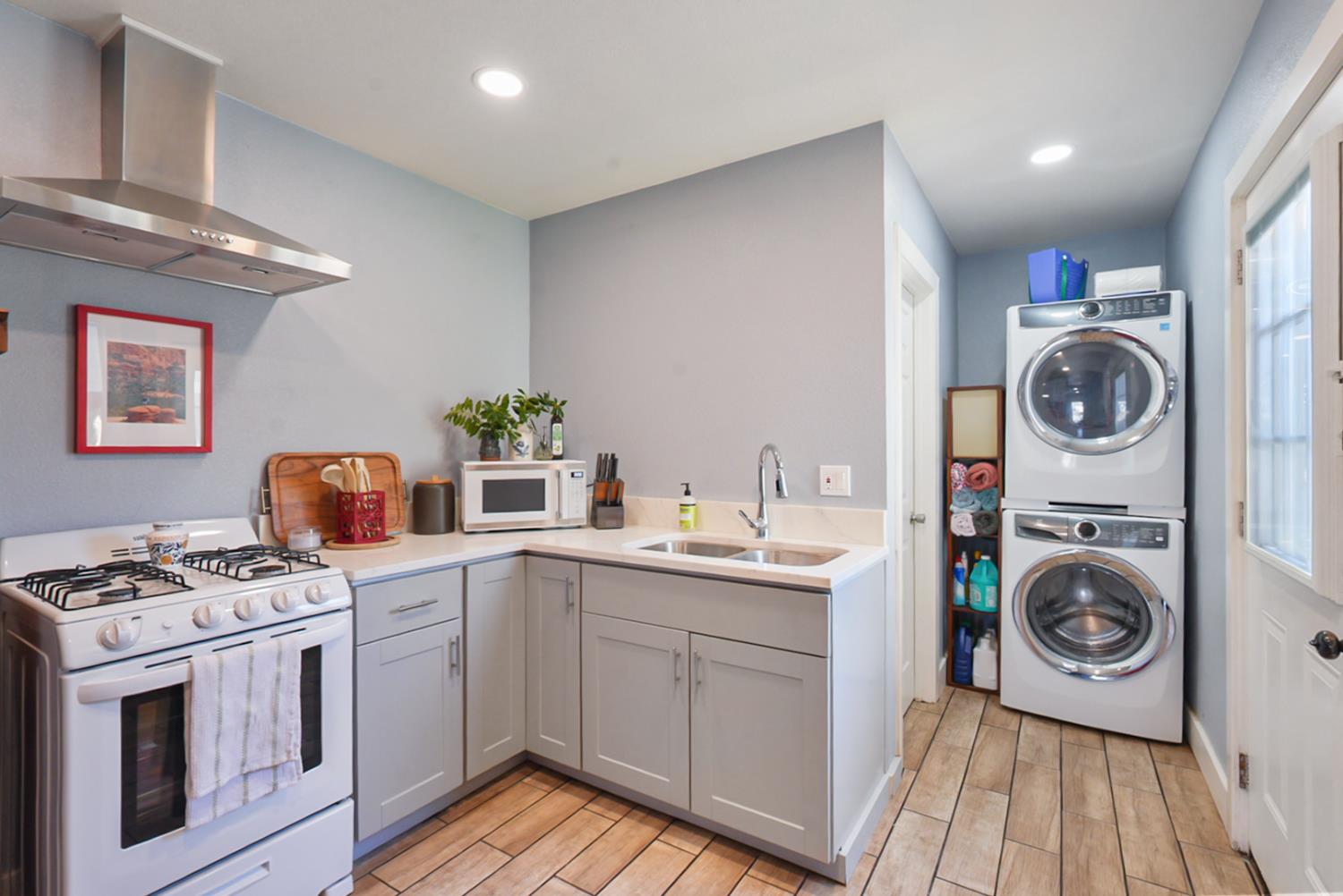 526 Flower Street Turlock, CA 95380 - Photo 13 of 28 a kitchen with stainless steel appliances a stove a sink and a cabinets