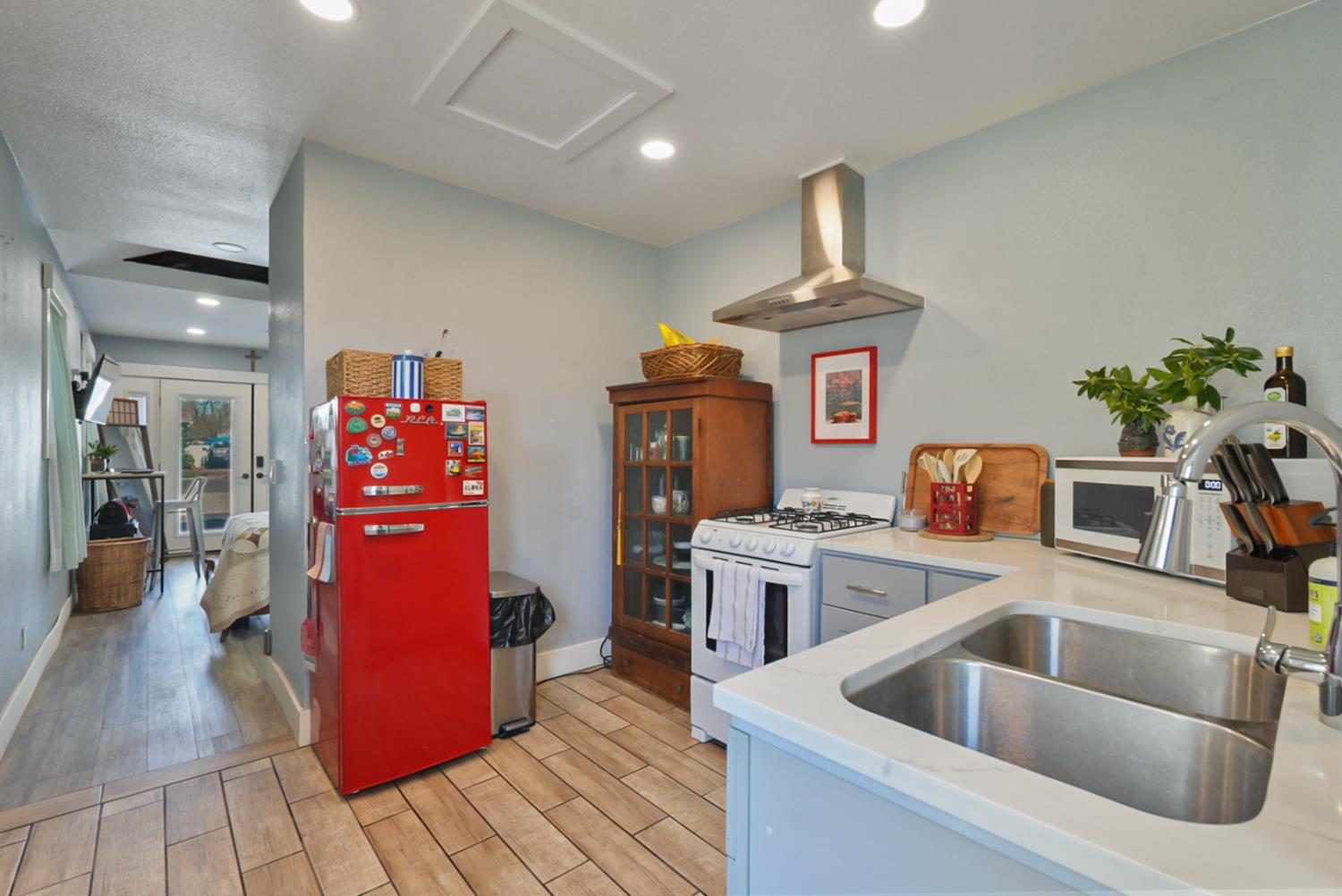 526 Flower Street Turlock, CA 95380 - Photo 14 of 28 a kitchen with stainless steel appliances granite countertop a sink and a refrigerator