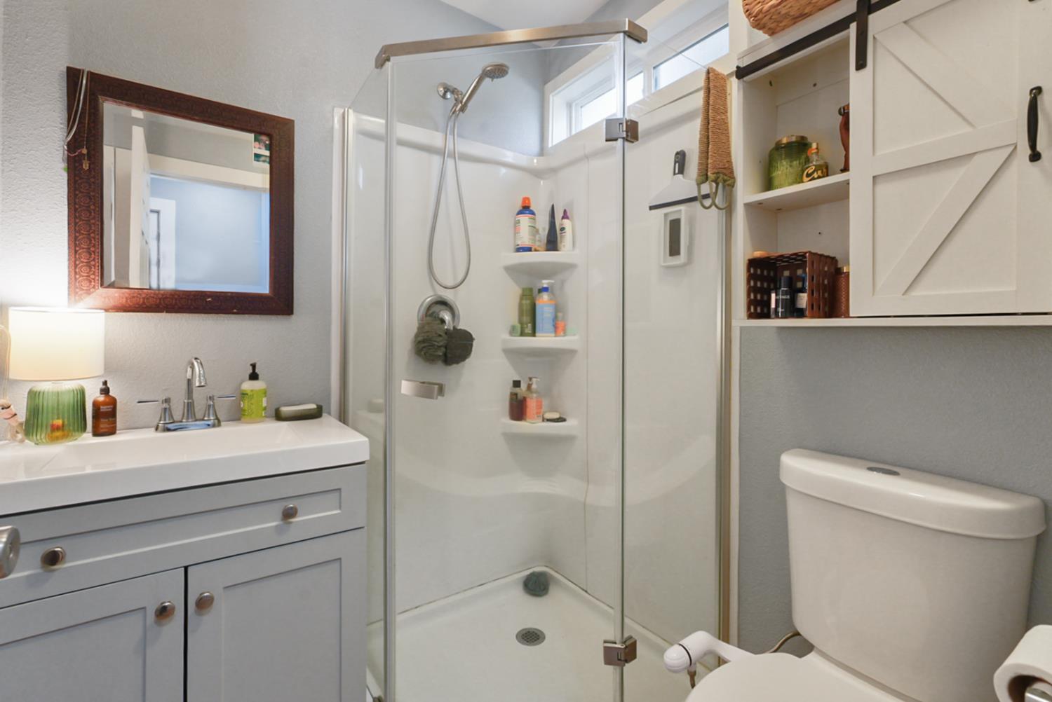 526 Flower Street Turlock, CA 95380 - Photo 15 of 28 a bathroom with a sink a toilet and shower