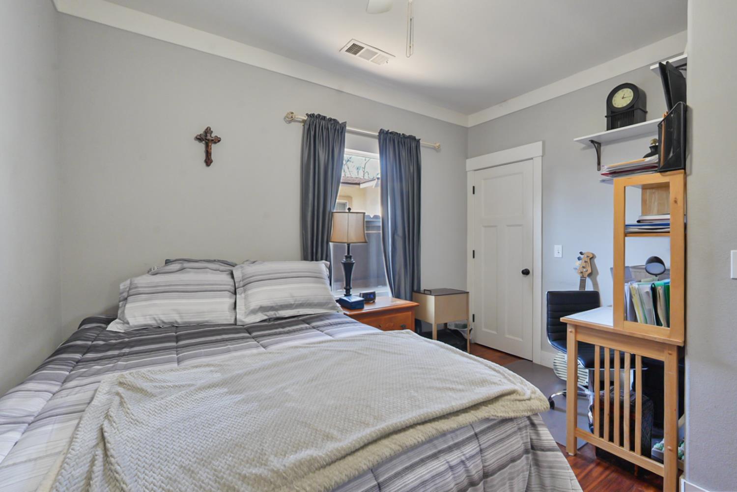 526 Flower Street Turlock, CA 95380 - Photo 20 of 28 a bedroom with a bed and a window