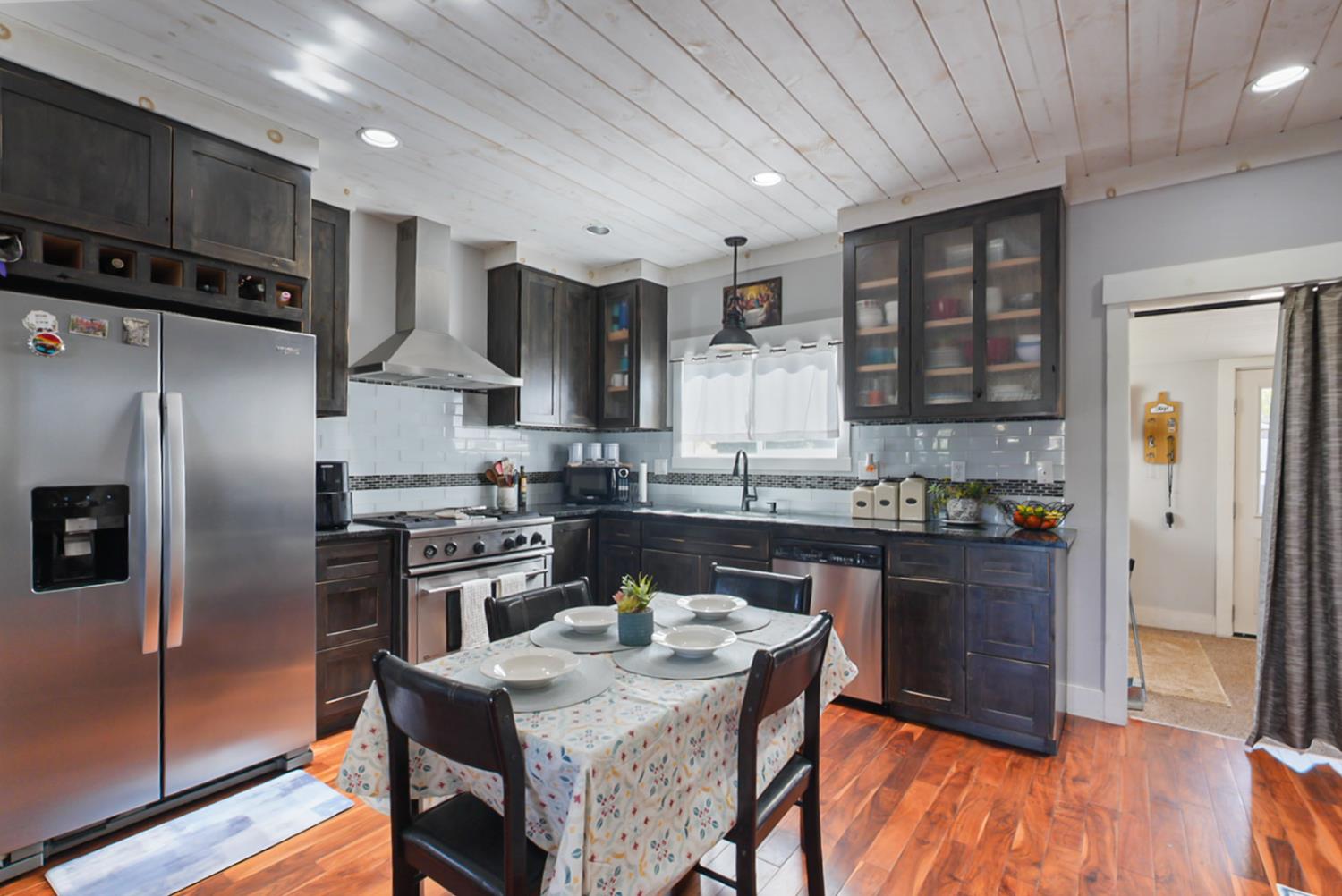 526 Flower Street Turlock, CA 95380 - Photo 6 of 28 a kitchen with granite countertop a refrigerator stove top oven and sink