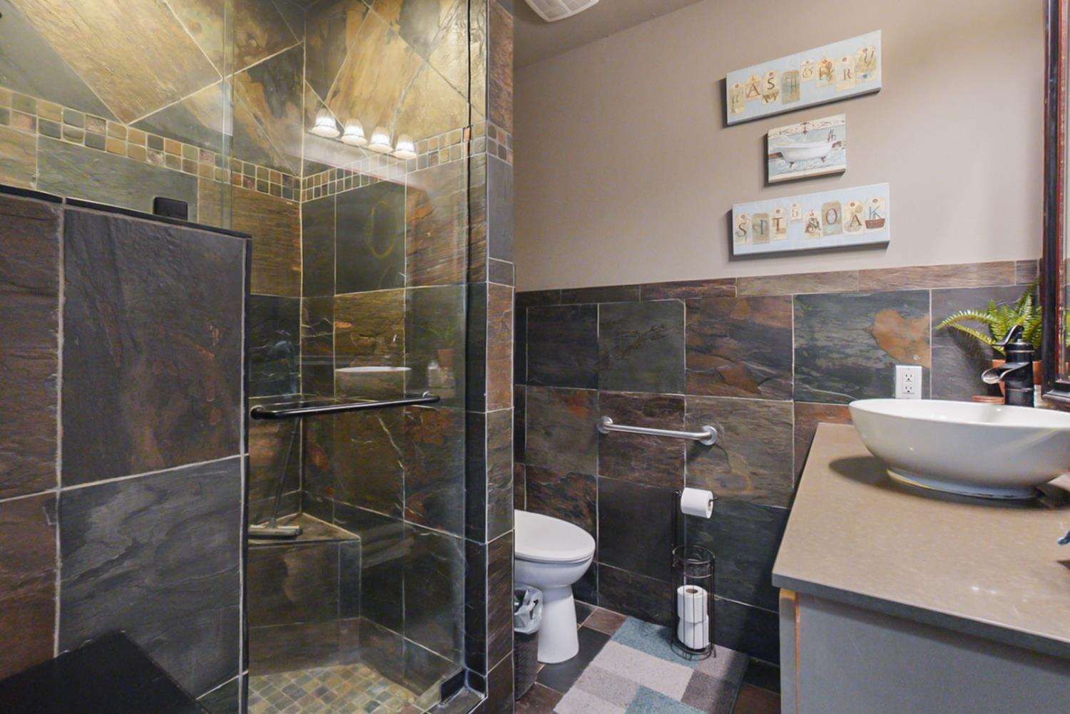 526 Flower Street Turlock, CA 95380 - Photo 10 of 28 a bathroom with a toilet and a sink