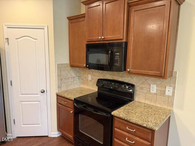 8227 Primanti Boulevard Raleigh, NC 27612 - Photo 9 of 25 a kitchen with granite countertop stove top oven and sink
