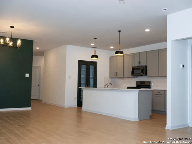 a large kitchen with cabinets and stainless steel appliances