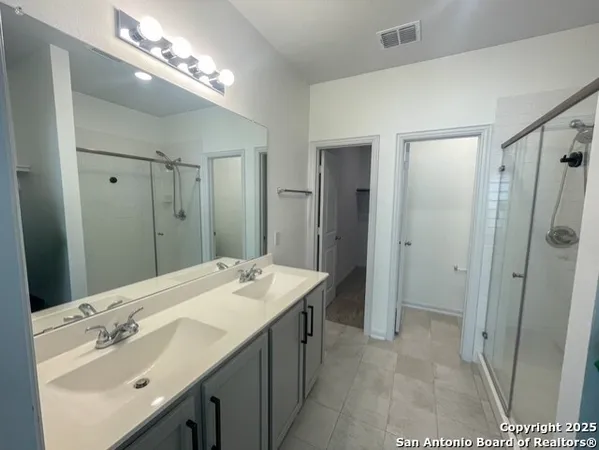 a spacious bathroom with double vanity sink and a mirror