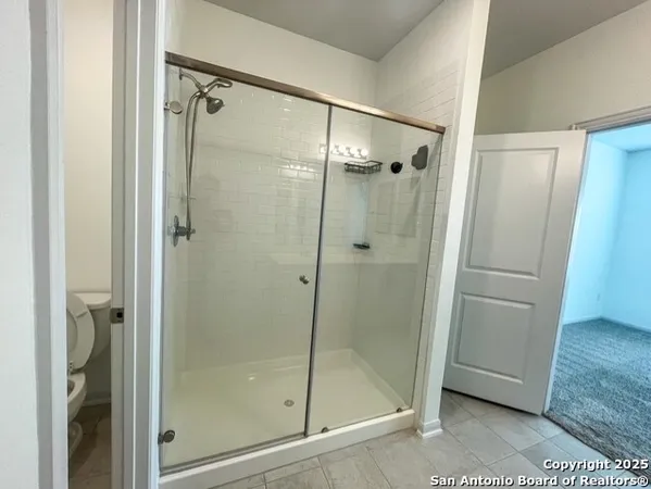 a bathroom with a glass shower door