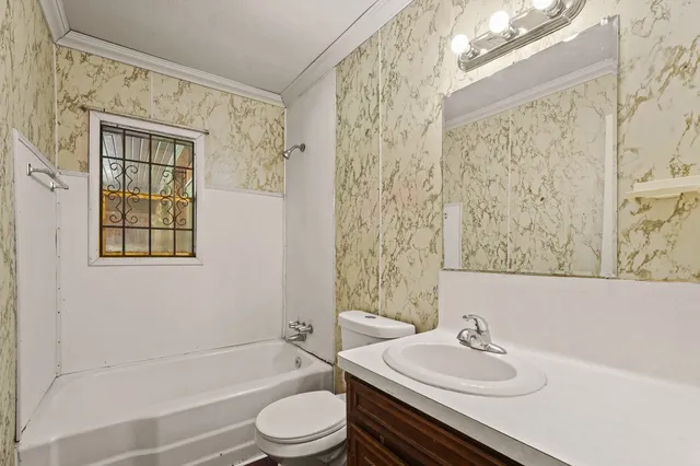 a bathroom with a sink toilet a mirror and shower