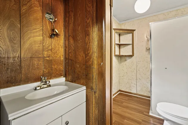 a bathroom with a sink toilet and shower