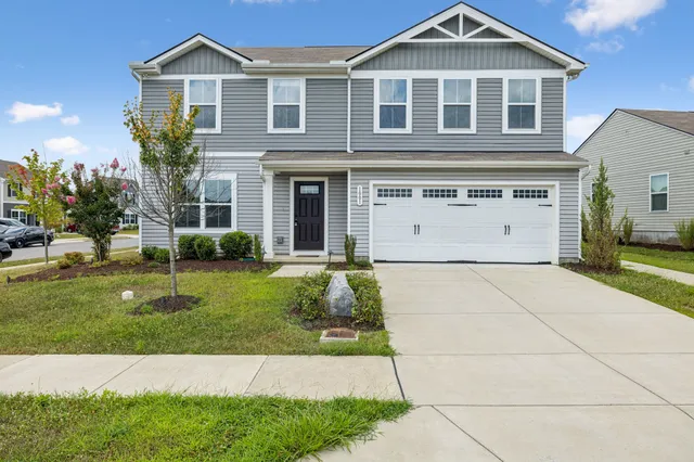 a front view of a house with a yard