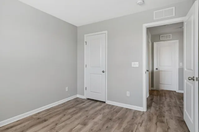 a view of a room with wooden floor