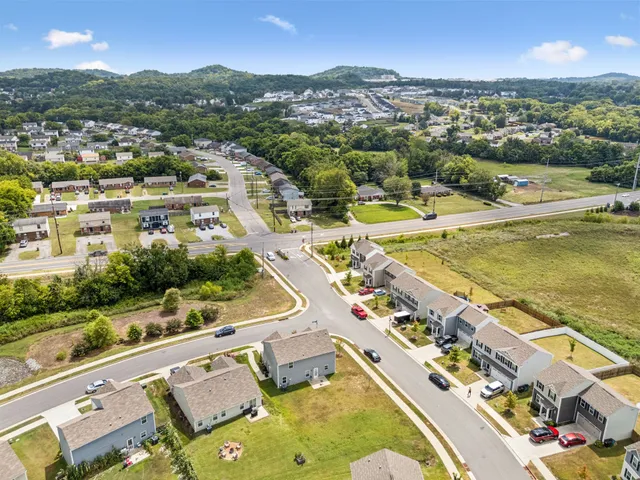 an aerial view of residential houses with outdoor space