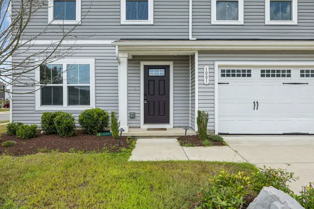 a view of a house with backyard and garden