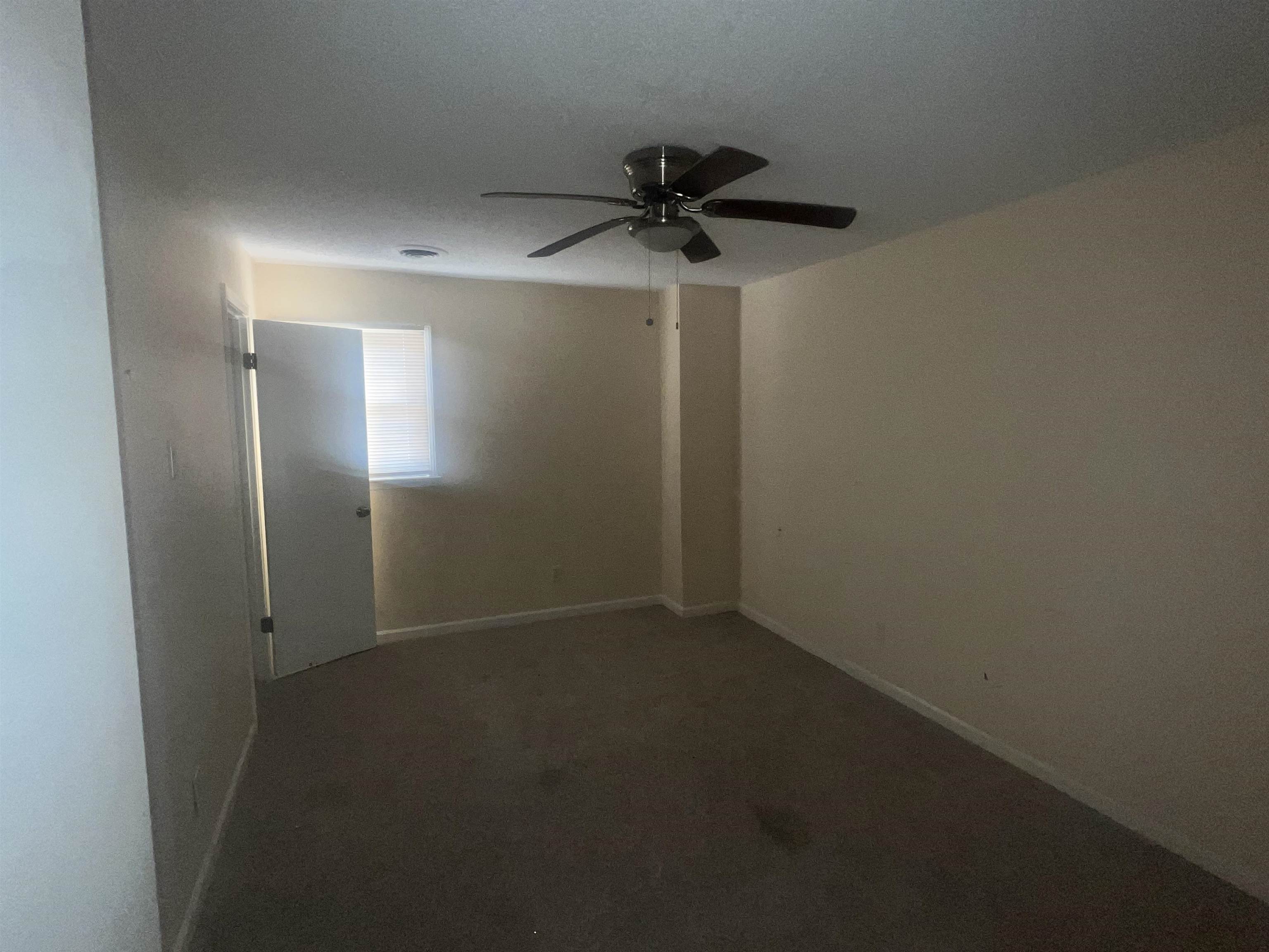 4295 Hudgins Road Memphis, TN 38116 - Photo 8 of 16 Neutral wall finishes and carpeted flooring