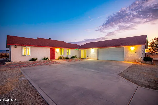 a view of large house with a yard and garage