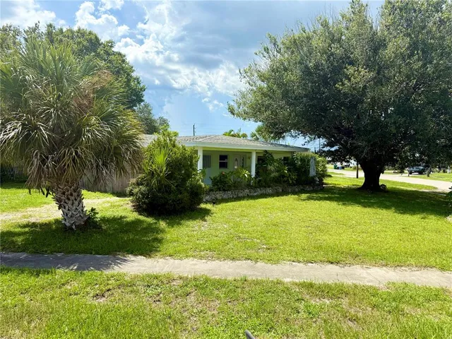 a front view of a house with yard and green space