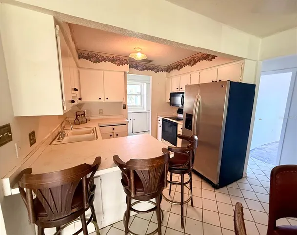 a view of a dining room with furniture and a large window