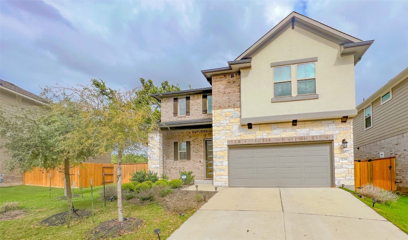 14218 McCoy Loop Austin, TX 78717 - Photo 1 of 1 a front view of a house with a yard and garage