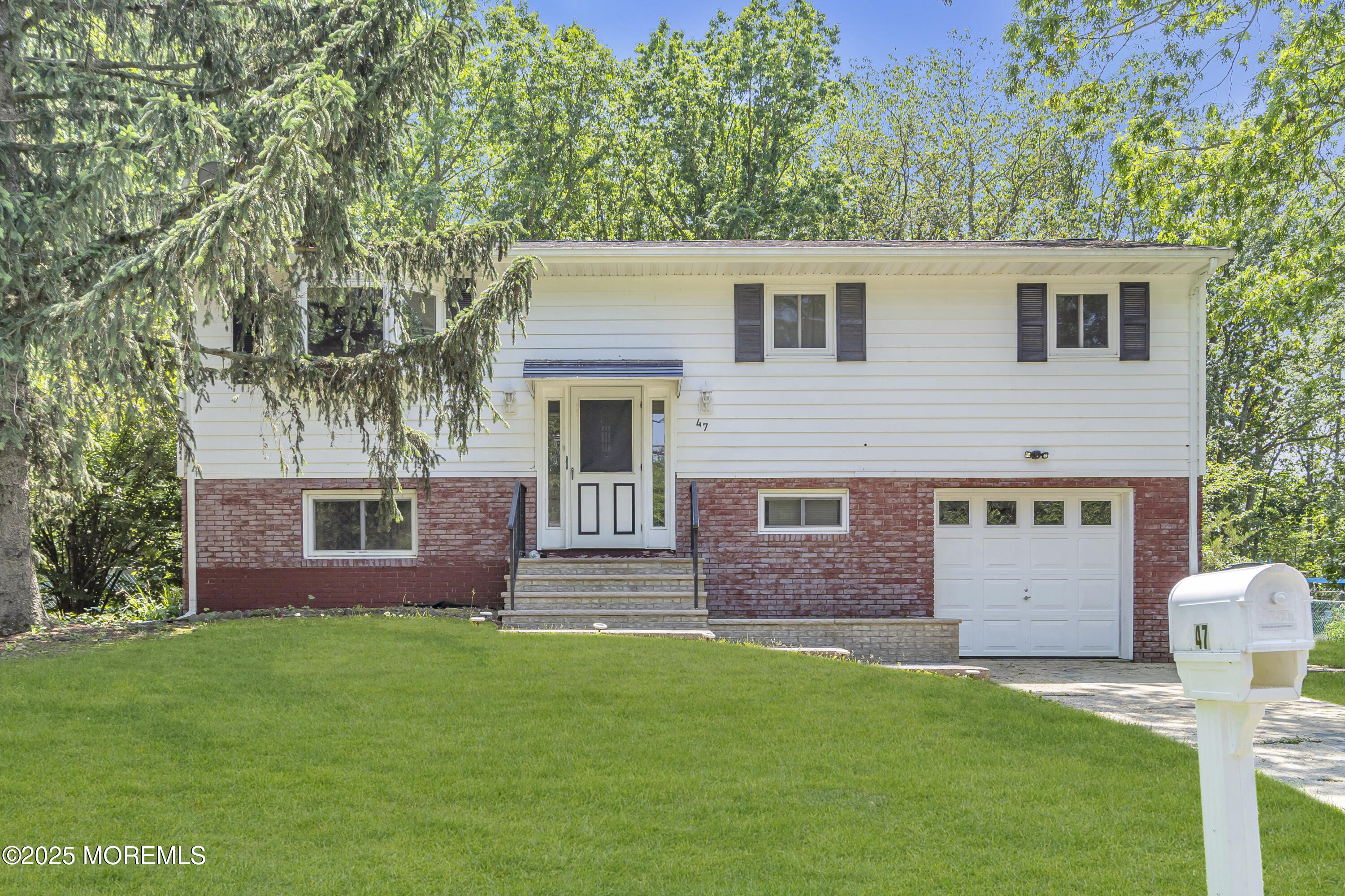 47 Beam Avenue Jackson, NJ 08527 - Photo 2 of 30 a front view of a house with a garden