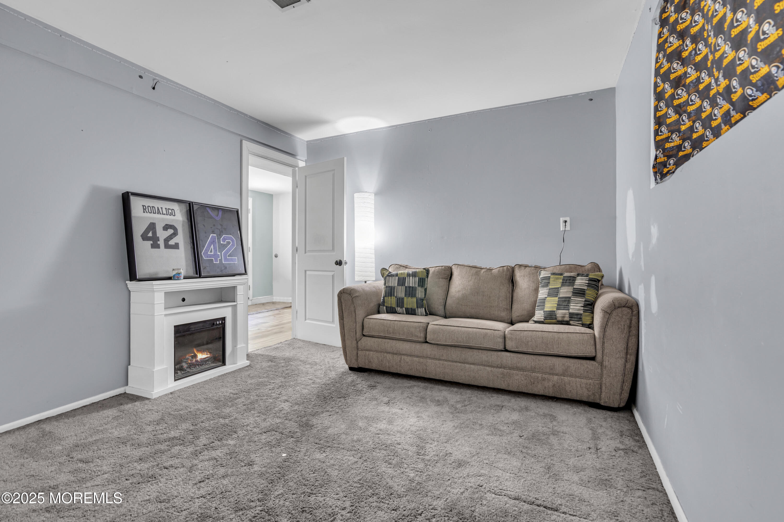 47 Beam Avenue Jackson, NJ 08527 - Photo 24 of 30 a living room with furniture a fireplace and a flat screen tv