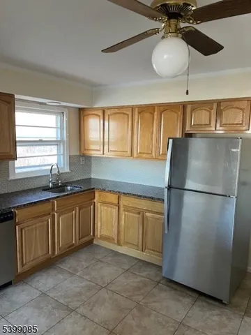 a kitchen with a stove cabinets and a refrigerator